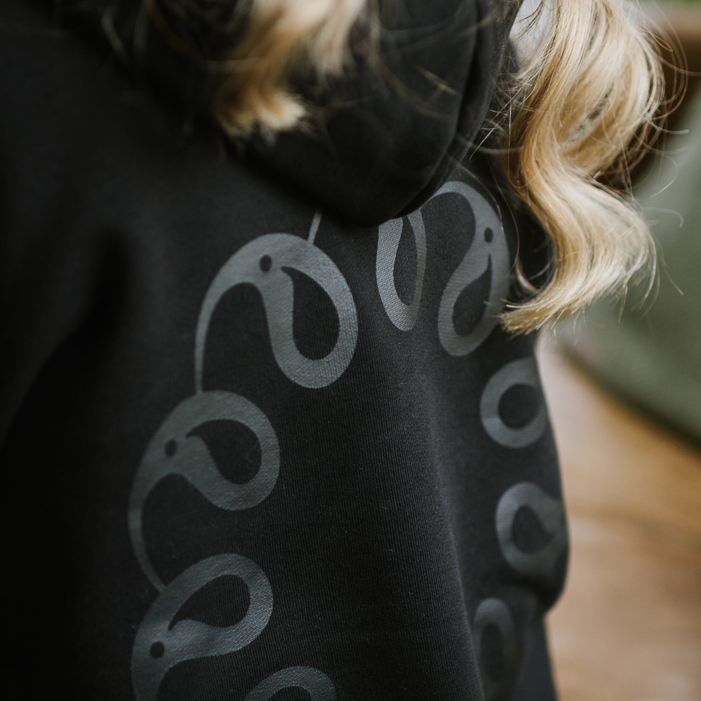 Back of black hoodie with logo by Every Little Thread