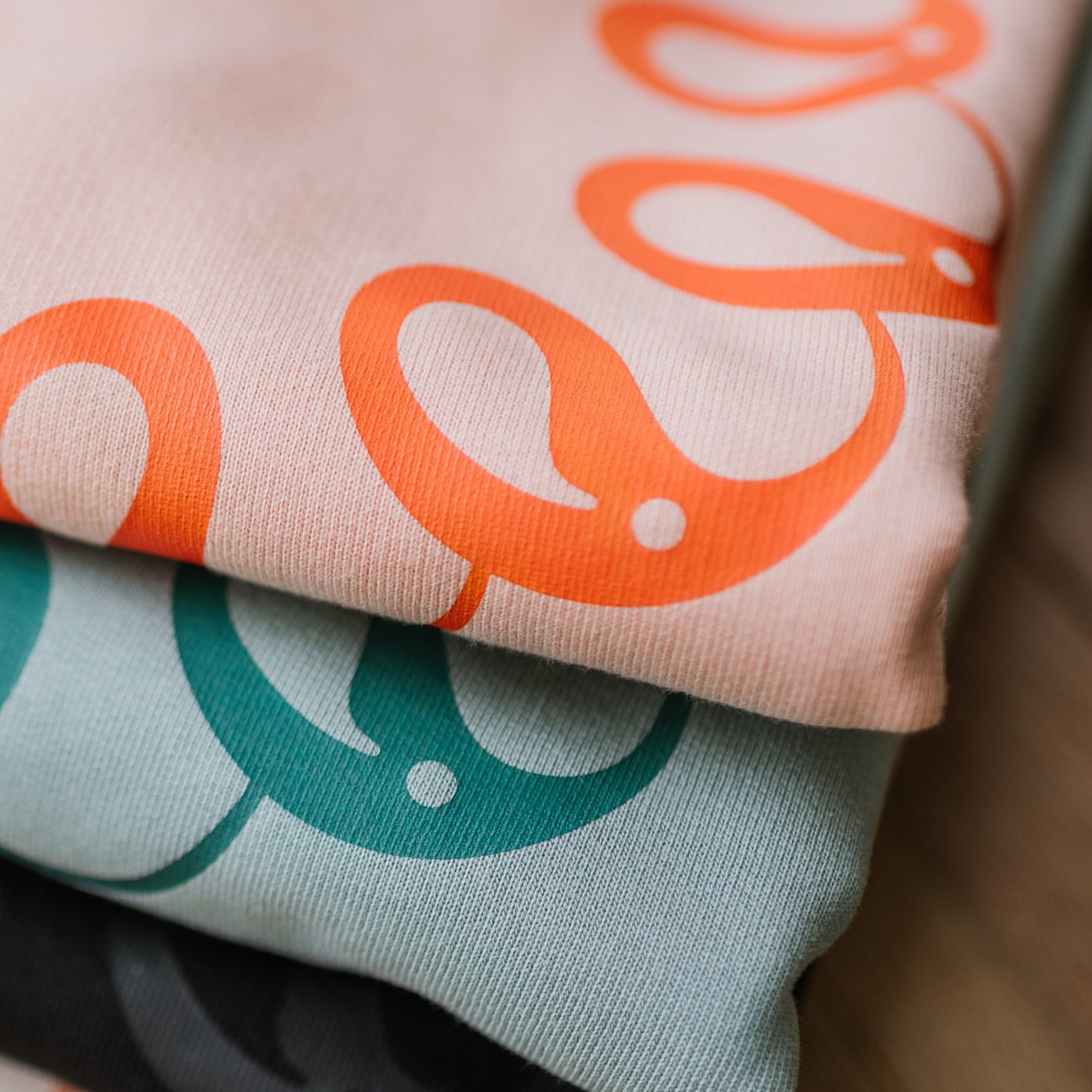 Close-up of Every Little Thread logo design on sweatshirts
