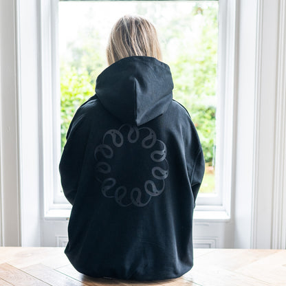 Back of black hoodie with logo by Every Little Thread