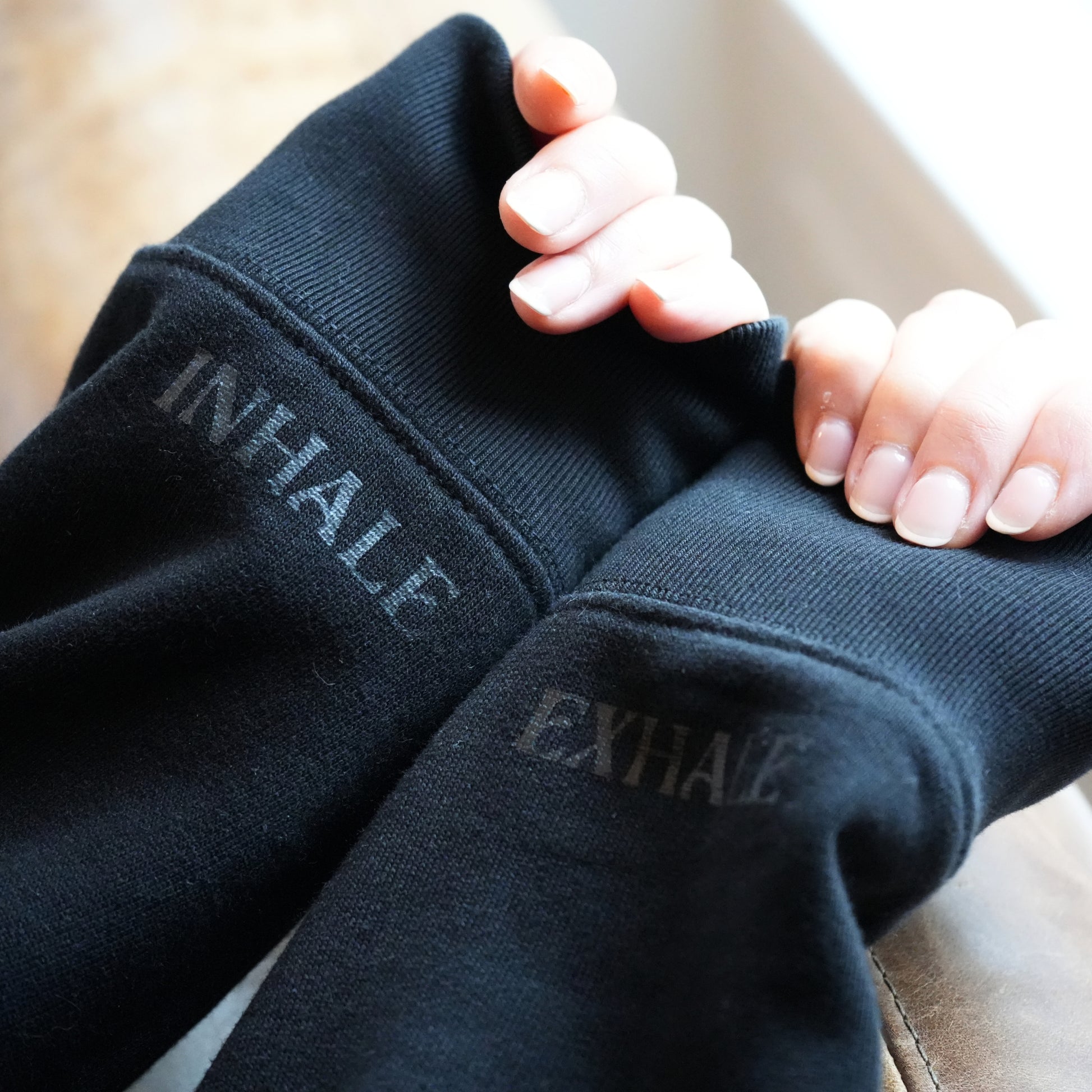 Black sleeves with 'INHALE' and 'EXHALE' text by Every Little Thread