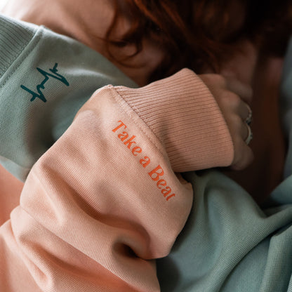 Close-up of Take A Beat Sleeves in Peach and Aloe colour by Every Little Thread